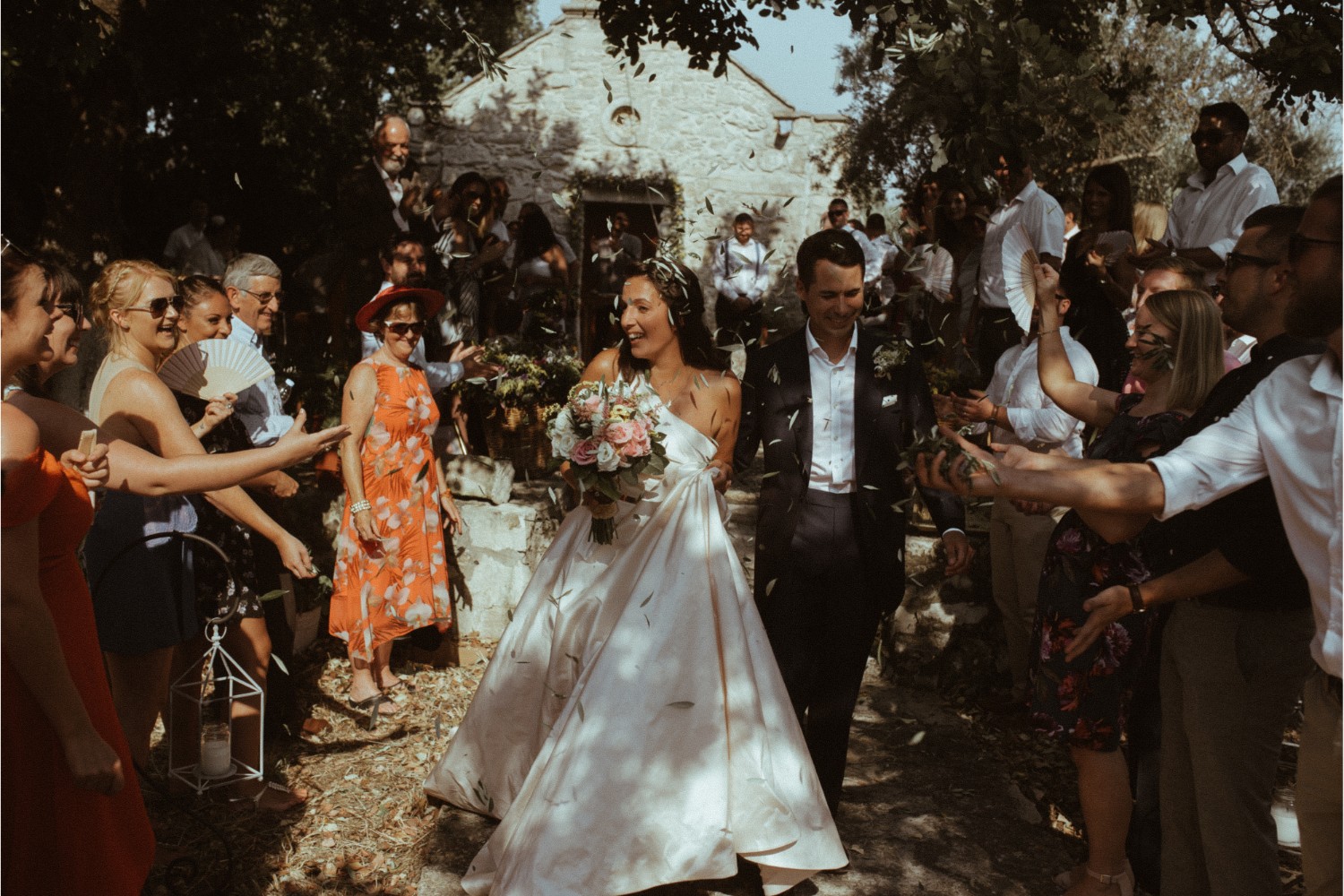 olive leaves confetti moment at villa wedding in Crete