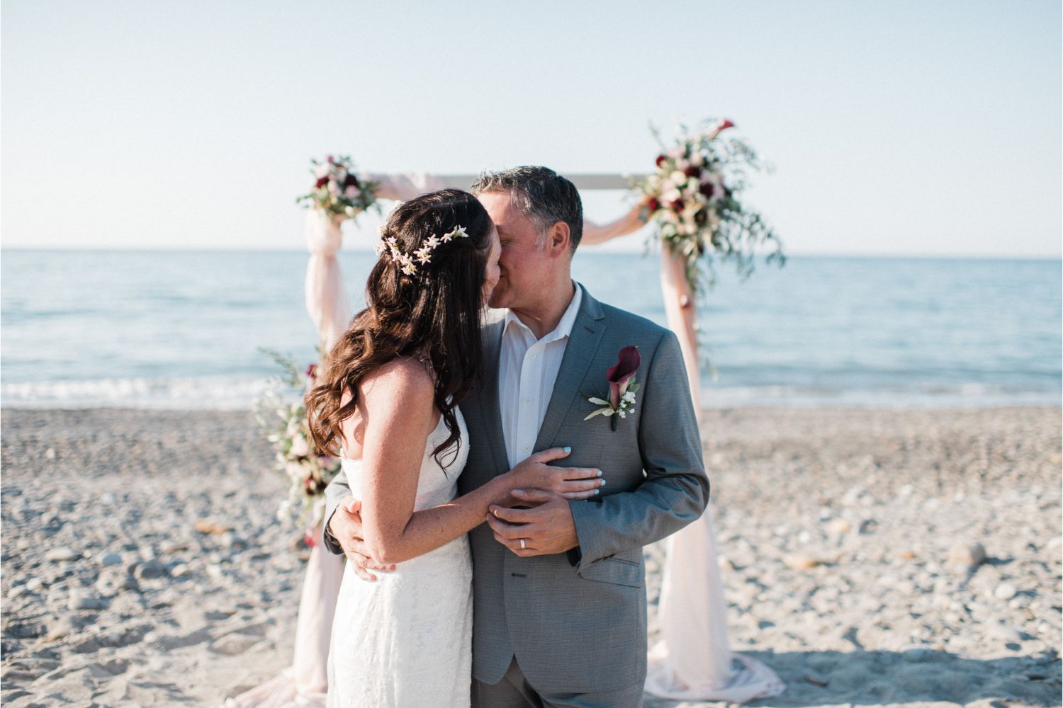 newlyweds at ceremony arch