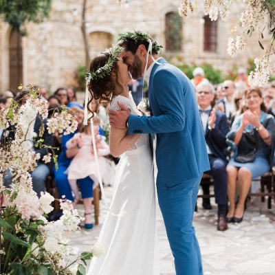 bride & groom first kiss at rustic wedding in Crete