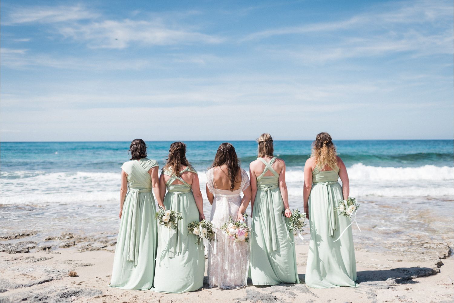 bride & bridesmaids at beach wedding in Crete