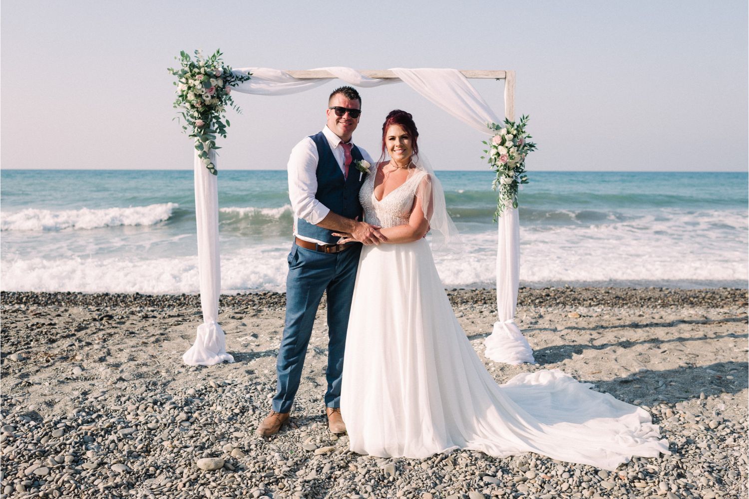 newlyweds at beach wedding ceremony in Crete