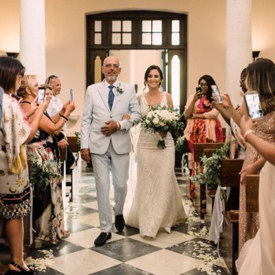 bride walking down the aisle at catholic church wedding in Crete