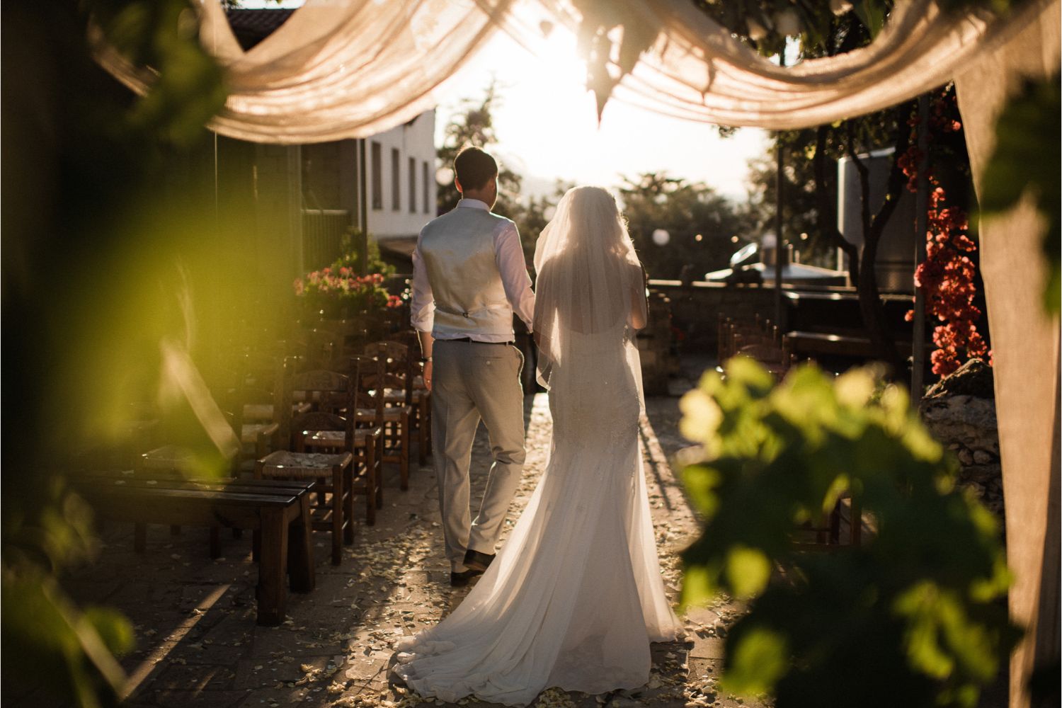 newlyweds walking up the aisle at winery wedding in Crete